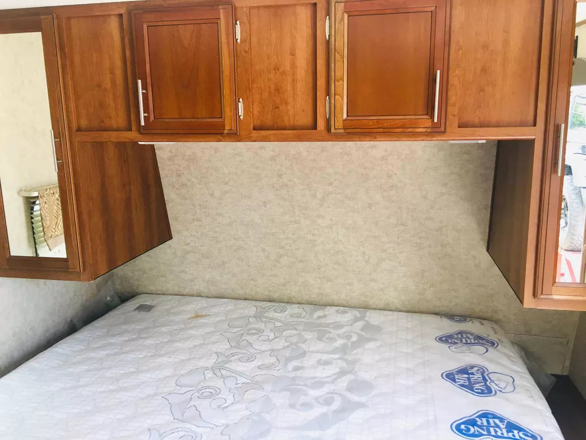 Recámara principal con cama Queen en el remolque camper